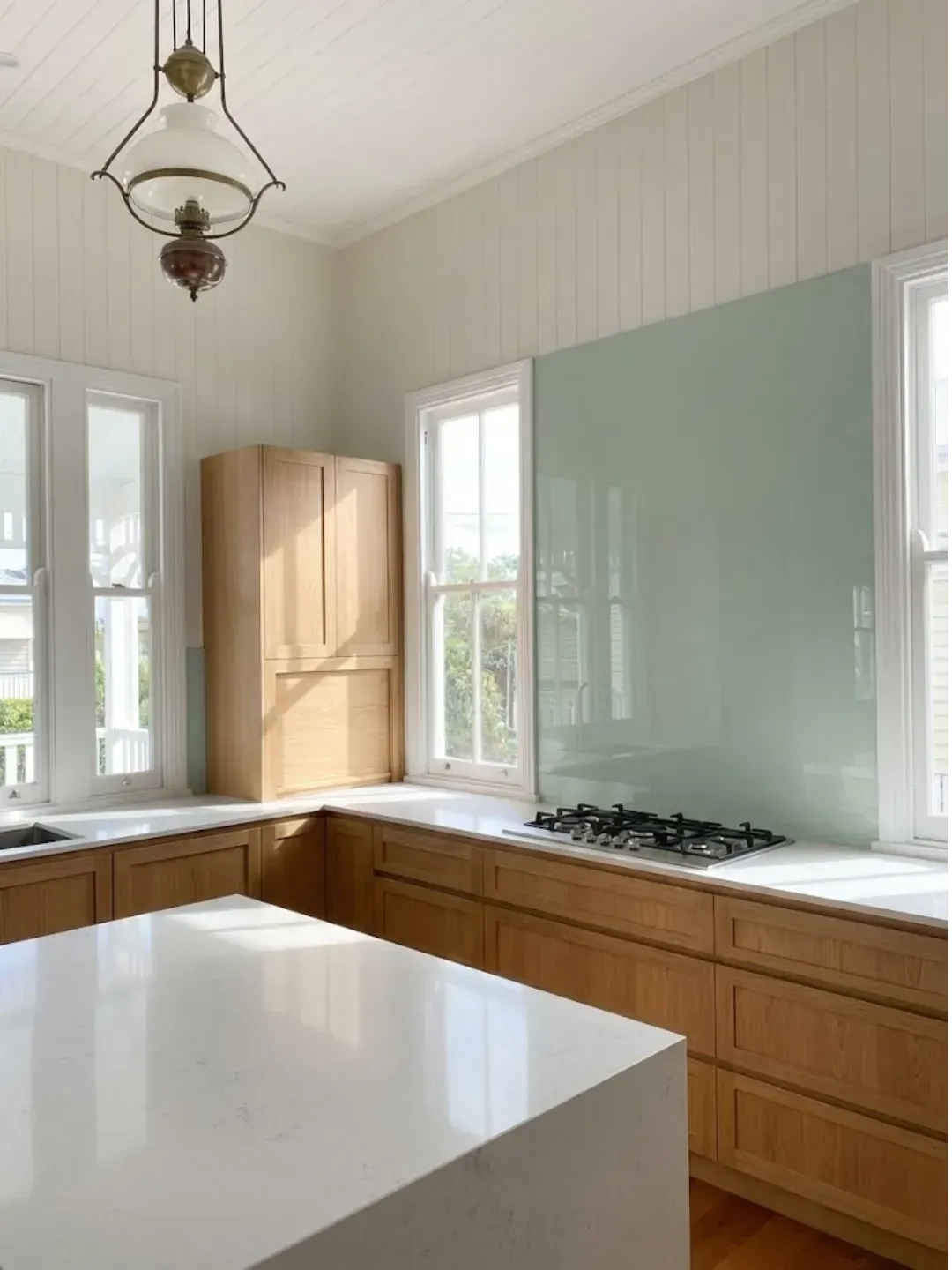 Custom coloured glass splashbacks South Brisbane with precision cut-outs for power points and millimetre-perfect fit.
